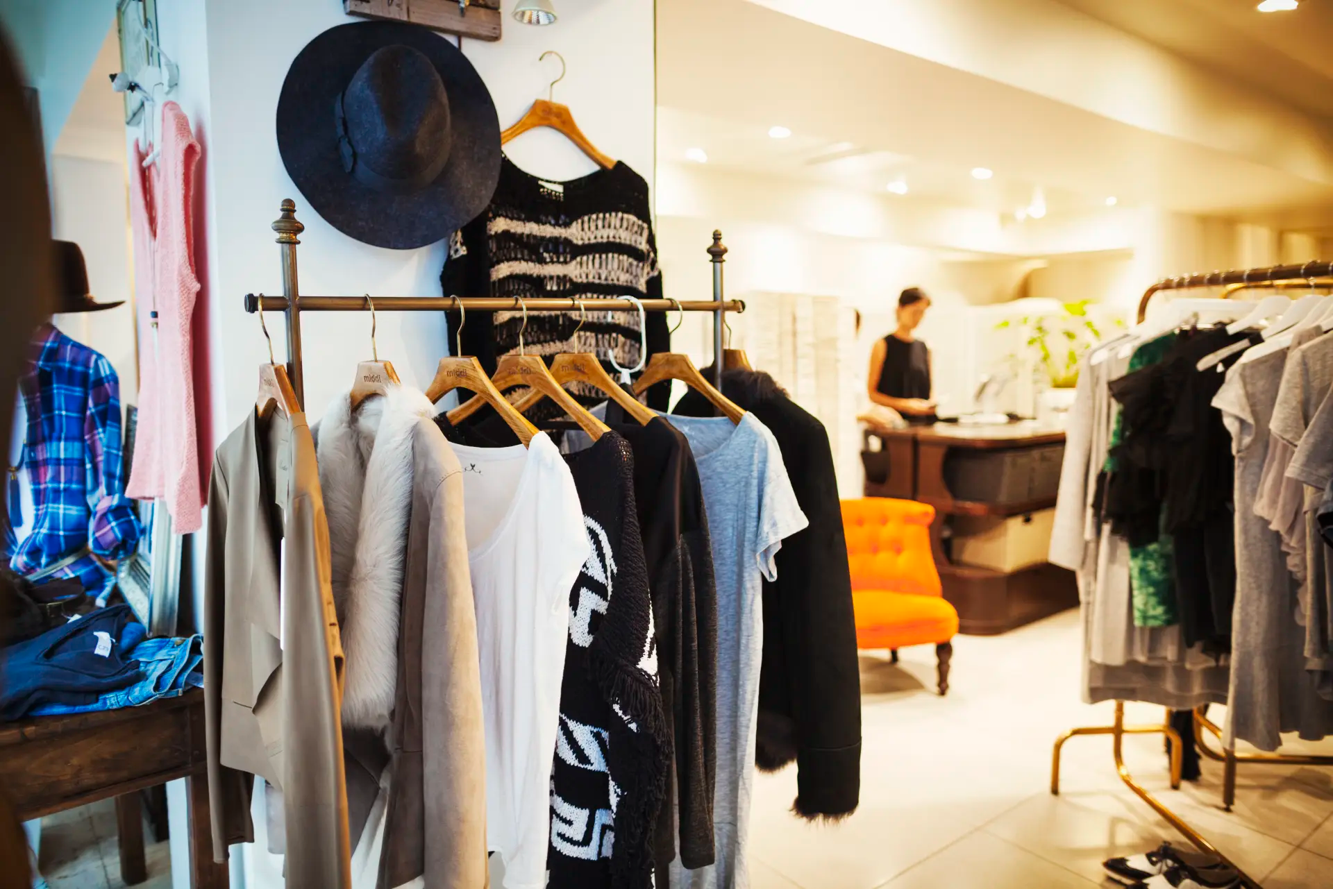 Products hanging on racks in a fashionable clothing boutique.